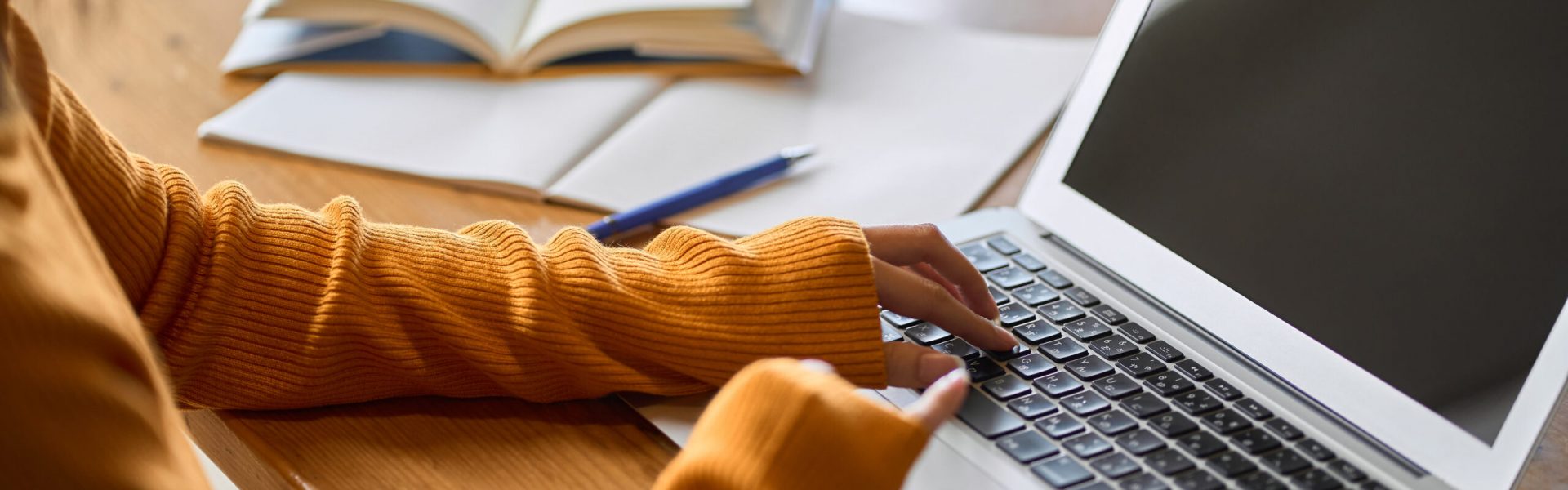 Asian woman's hand studying for qualifications