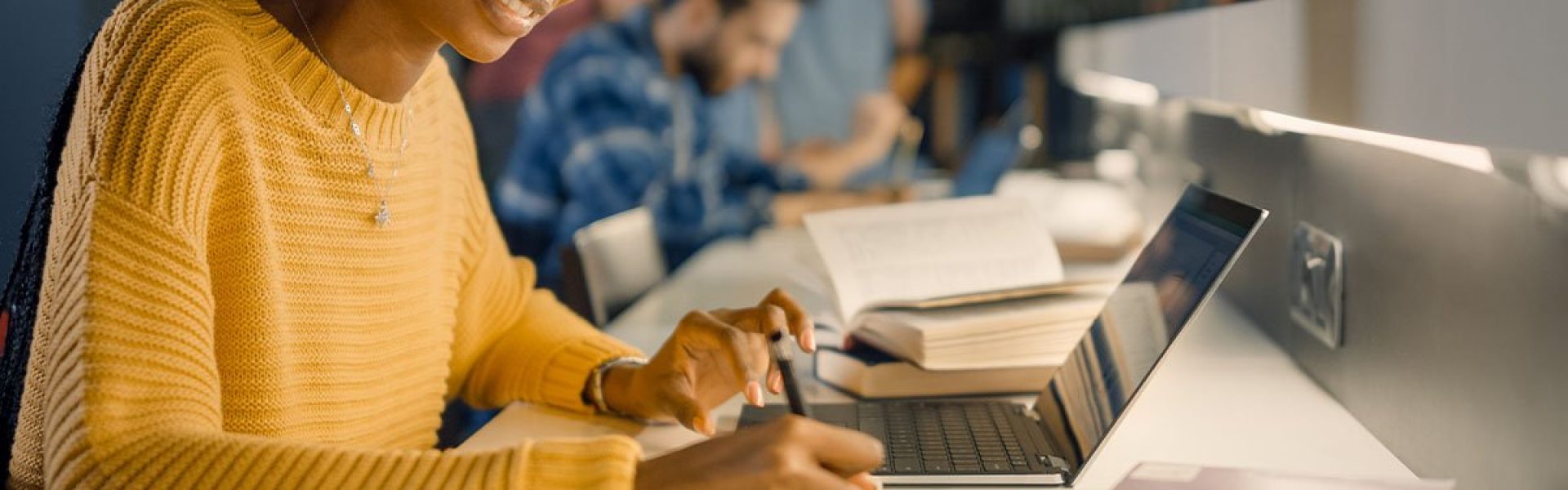 Student writing in library